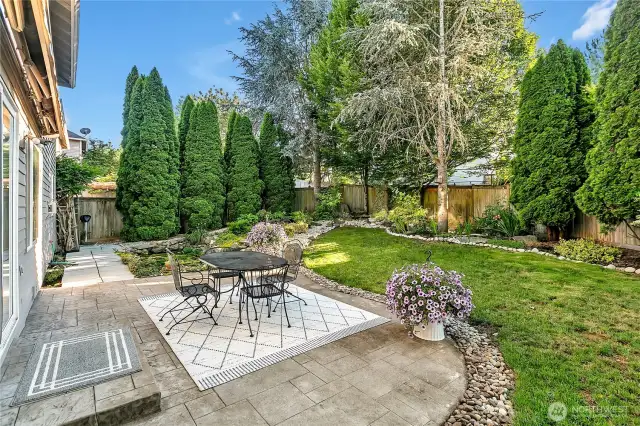 The large stamped concrete patio, which sets nicely against the water feature-a formal pond with a watercourse.
