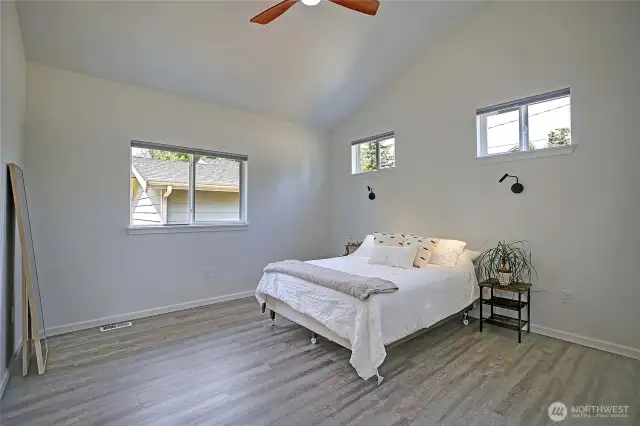Master bedroom very large with vaulted ceilings and reading lights and ceilings fan.