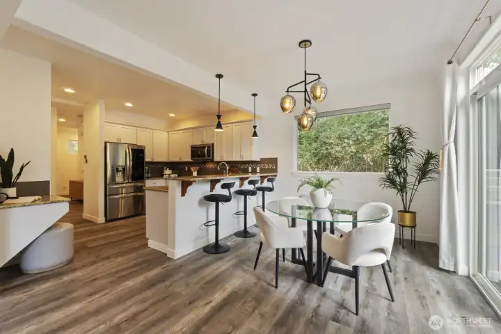 The dining and kitchen, showing the tech desk to the left and the slider to the backyard to the right.