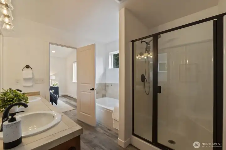 Primary en-suite has two sinks, tub & shower, and a spacious walk-in closet