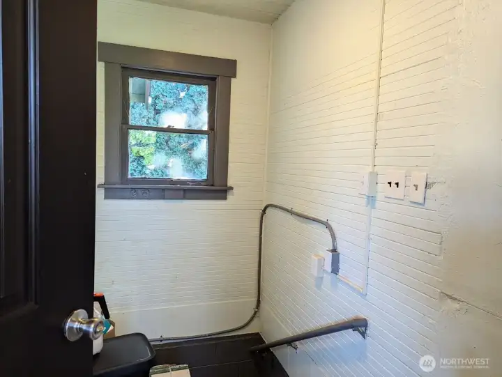 Enclosed staircase from kitchen to basement and garage.