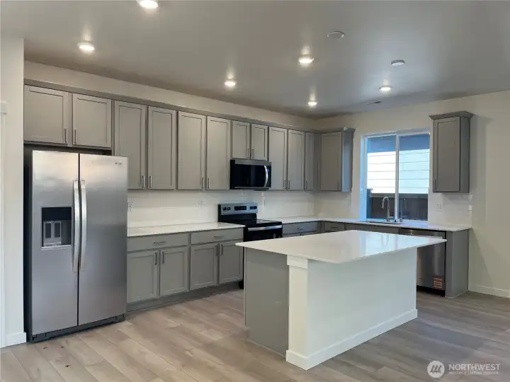 Kitchen with island and included appliances