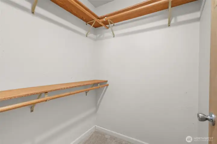 Walk in closet in primary suite.