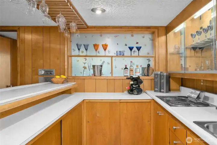 With a cooktop, sink and fridge - the bar provides a 2nd kitchen