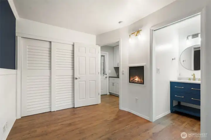 Second bedroom w/it's own half bath & wall fireplace,  toward hallway and side door.