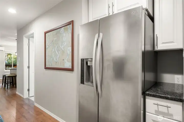 Hallway from side door/second bedroom toward main bath and kitchen.  Large second refrigerator/freezer and extra storage here.