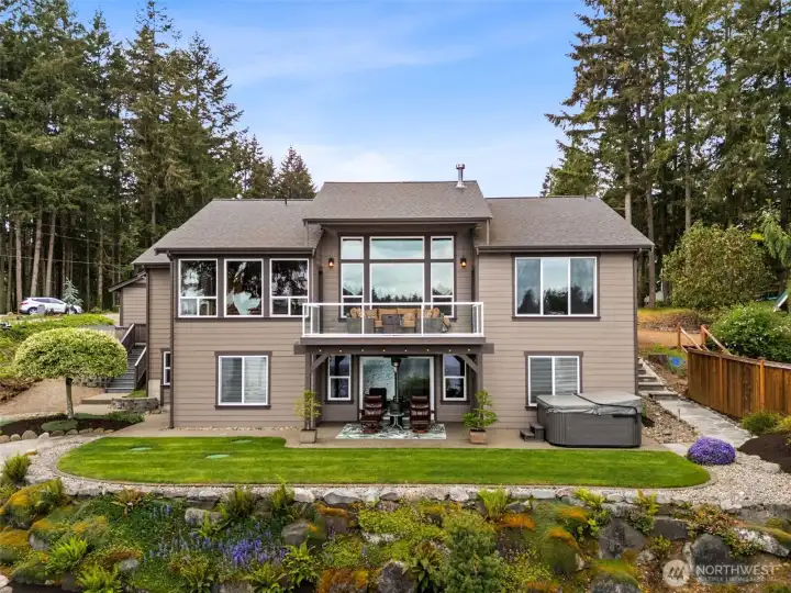 So many waterfront homes end up sacrificing functional yard space because everything slopes aggressively toward the water, but here the lawn stays surprisingly level and open, creating the perfect setup for croquet, lawn games, barefoot summer evenings or simply stretching out in the grass watching the lake shimmer in the background. The terraced design keeps the property visually interesting while still making the outdoor spaces feel comfortable and accessible. You can also spot the three green septic lids tucked neatly into the lawn on the left side, identifying the septic system location for this property, which is rated for a three-bedroom system.  So many waterfront homes end up sacrificing functional yard space because everything slopes aggressively toward the water, but here the lawn stays surprisingly level and open, creating the perfect setup for croquet, lawn games, barefoot summer evenings or simply stretching out in the grass watching the lake shimmer in the background.