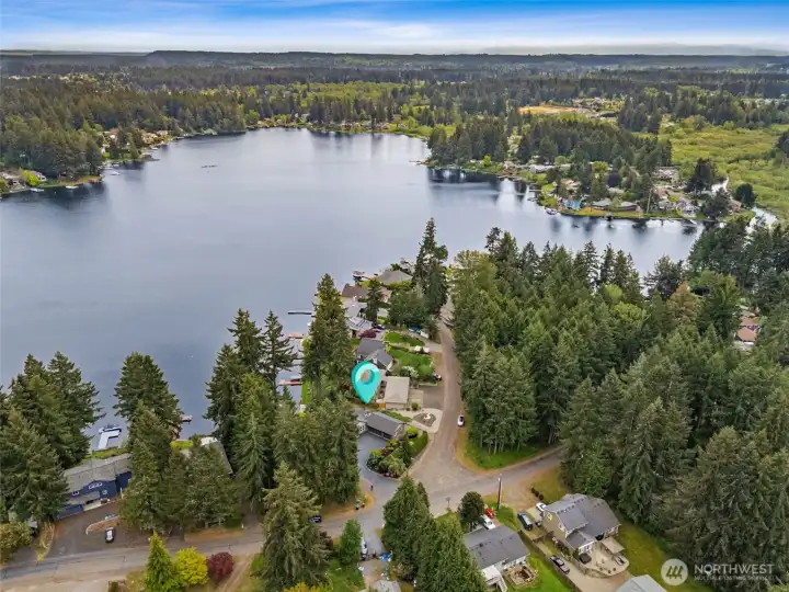 This aerial looks toward the quieter end of Long Lake where you’ll find the Long Lake Natural Area, a beautiful natural section of the lake that many local anglers swear offers some of the best fishing around. The more protected waters and natural shoreline habitat in this area help create excellent conditions for fish activity, making it a favorite destination for early morning casts and peaceful afternoons on the water. From this perspective, you also get a great sense of how the home enjoys access to all the fun recreational energy of the lake while still being connected to these calmer, nature-focused stretches nearby.