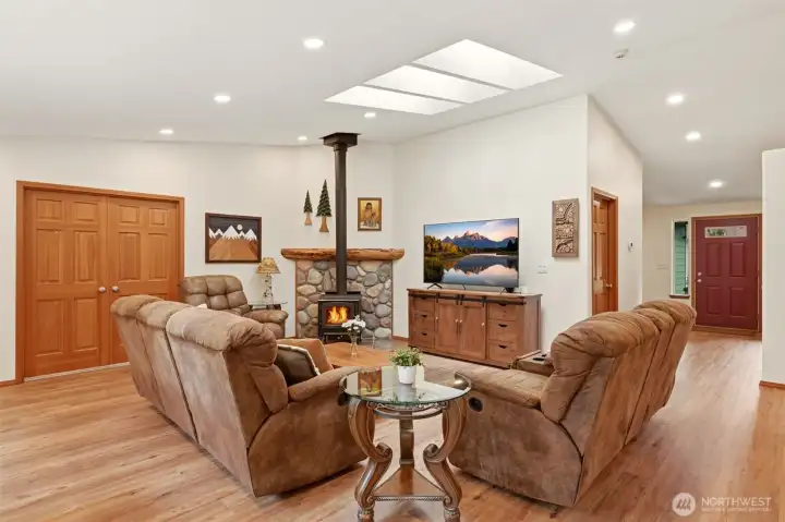 Open Living Room Space with tons of natural light from Skylights with wood burning fireplace