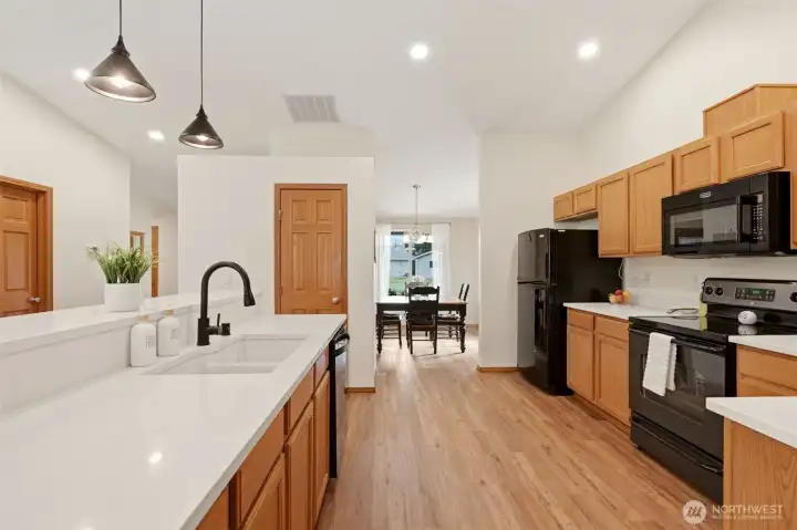 Big Open Kitchen with Quartz countertops and updated flooring and a pantry