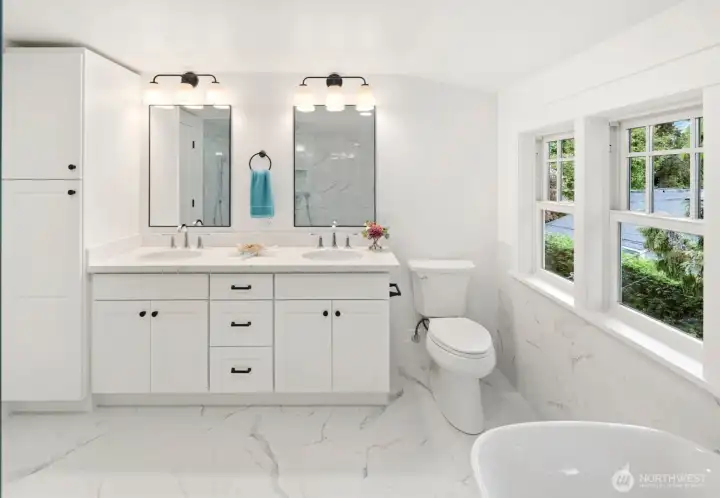 Double vanity, quartz slab tops, undermount sinks, and designed tile everywhere!