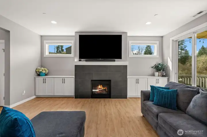 Elegance meets modern residential style. Relax in your new living room with a gorgeous electric/gas fireplace and quickly venture to the outdoor areas through the two sliding glass doors.