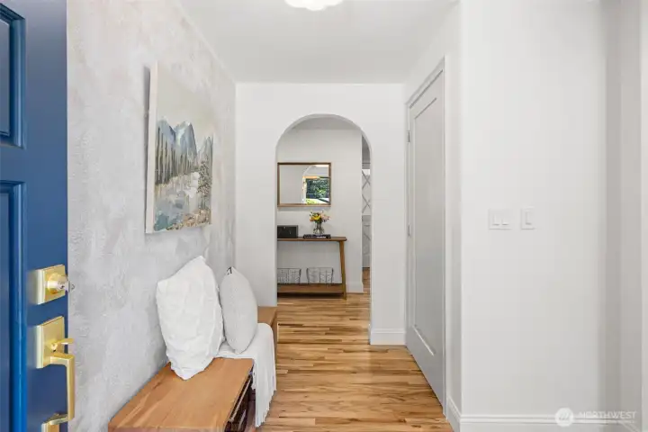 The entry way is highlighted by the arched doorway- complete with coat closet and space to greet your guests.