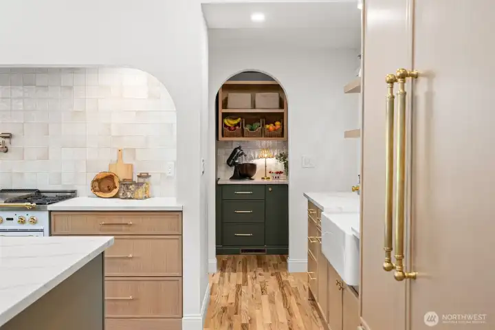Pantry off the kitchen has plenty of storage and market shelves to tastefully store all your supplies.