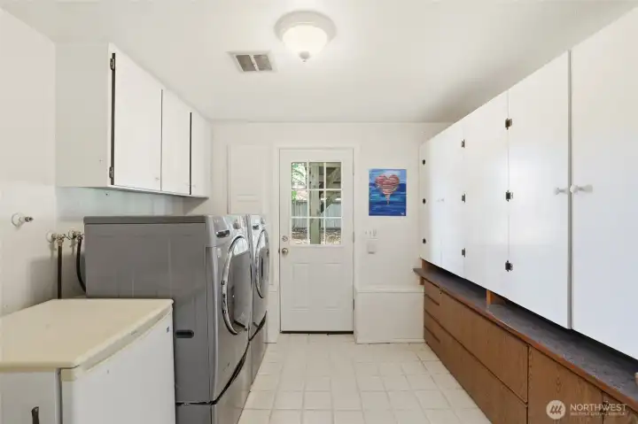 The spacious laundry room offers an abundance of cabinet storage and convenient access to the backyard, adding both functionality and ease to everyday living. The spacious laundry room offers an abundance of cabinet storage and convenient access to the backyard, adding both functionality and ease to everyday living.