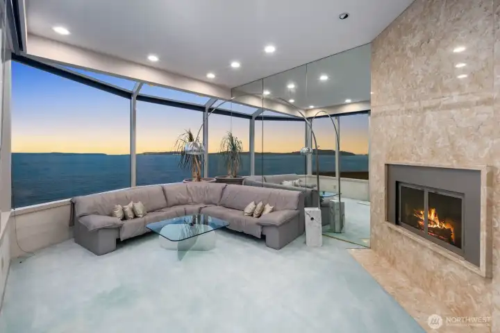 Walls of windows frame sweeping Puget Sound views, creating a dramatic living space designed to maximize natural light and waterfront scenery. Walls of windows frame sweeping Puget Sound views, creating a dramatic living space designed to maximize natural light and waterfront scenery.