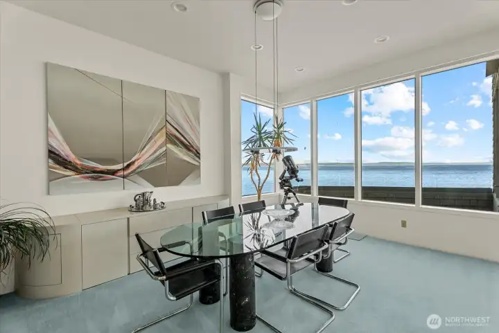 Dining area positioned to capture panoramic Puget Sound views through expansive windows. Dining area positioned to capture panoramic Puget Sound views through expansive windows.