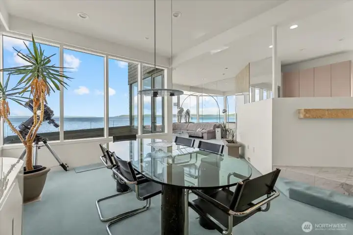Open dining and living spaces create an inviting setting for everyday meals and waterfront entertaining. Open dining and living spaces create an inviting setting for everyday meals and waterfront entertaining.