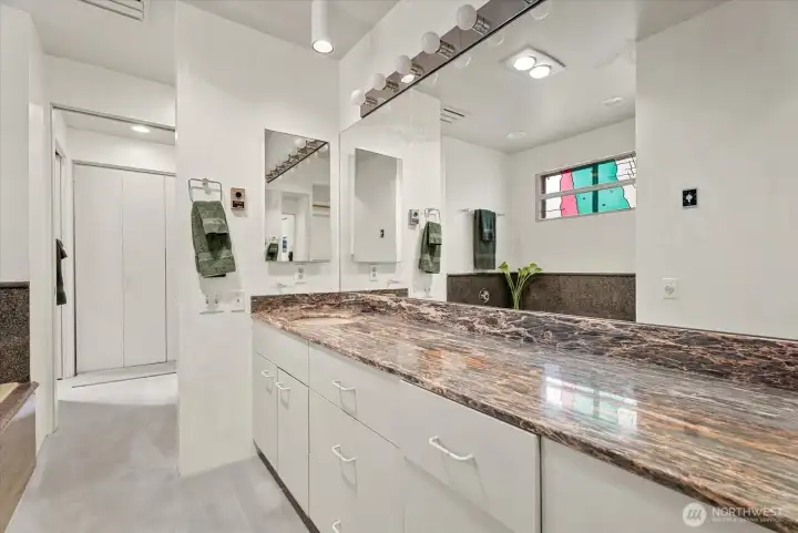 Private primary bath featuring a large vanity, ample storage, and access to the adjoining walk-in closet. Private primary bath featuring a large vanity, ample storage, and access to the adjoining walk-in closet.