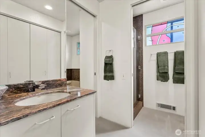 Primary bath combines a jetted soaking tub, walk-in shower, and generous storage. Primary bath combines a jetted soaking tub, walk-in shower, and generous storage.