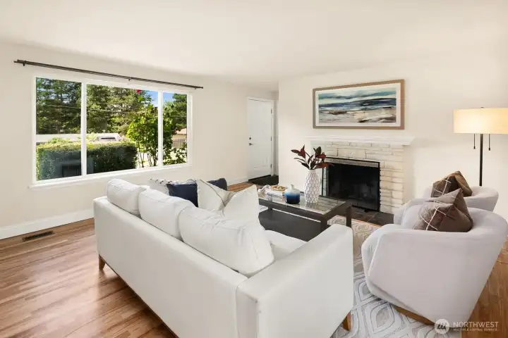 Living room features a wood burning fireplace and newly refinished hardwood floors.