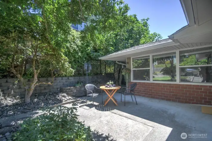 The front yard provides a private garden area with hardscaped walls and planters - a gardener's oasis