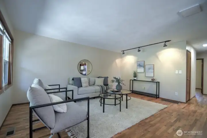 To the left of the entry is this bright, open living room. Notice the newly finished hardwood floors and new interior paint throughout the home.