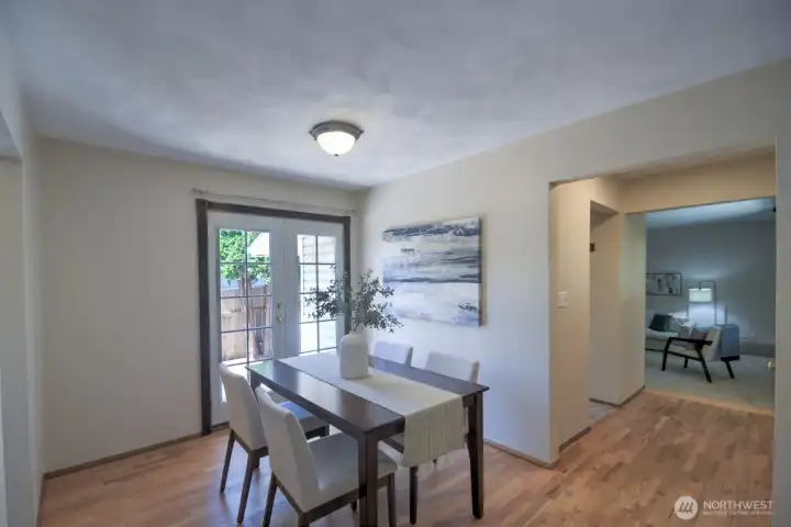 The dining room is located off of the kitchen and is adjacent to the living room. French doors lead to the backyard deck for more entertaining space.