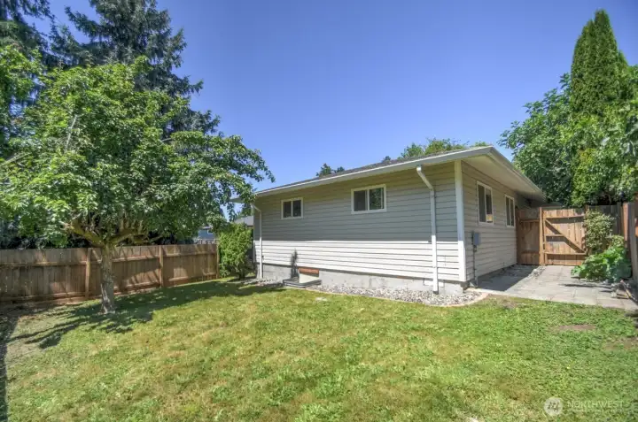 View of spacious fenced backyard
