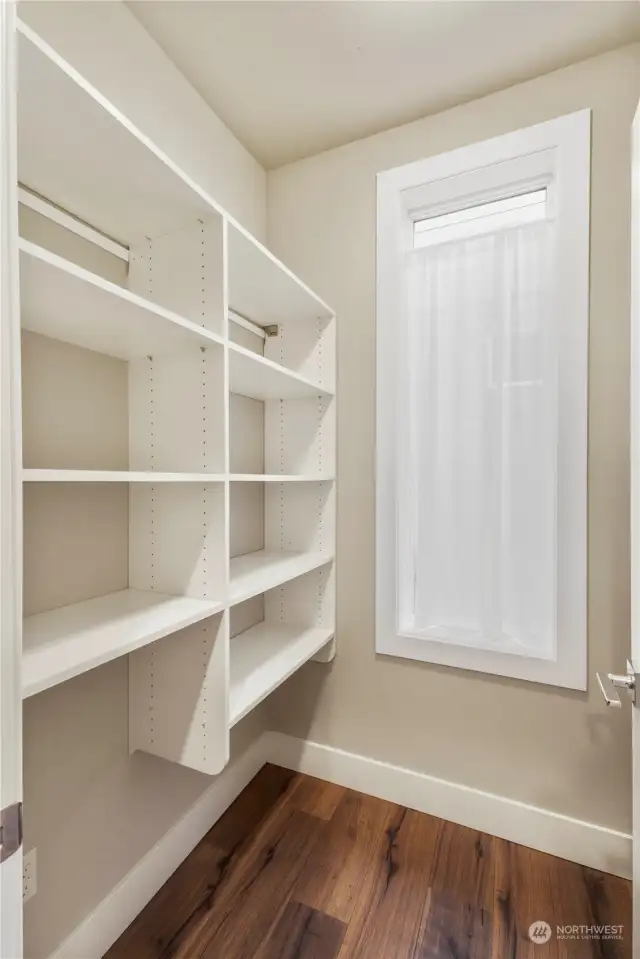 A walk in pantry with window and space for your wine fridge is perfect for your staples & Costco runs