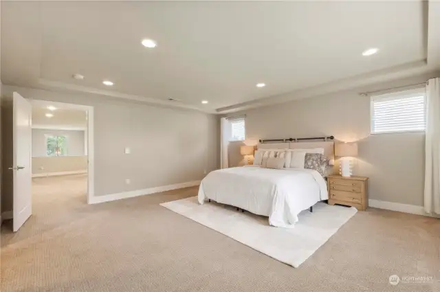 The primary bedroom is a true retreat! The generous space offers coffered ceilings and has room for relaxing & peaceful sleep