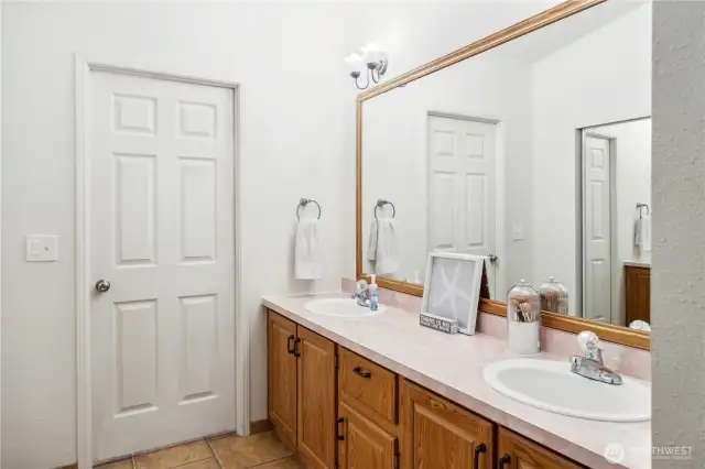 Large counter space with double sinks.Door to the shower and toilet