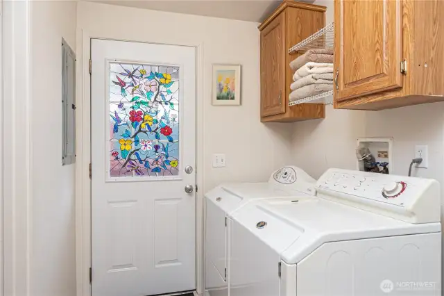 Laundry room with a door to the back porch