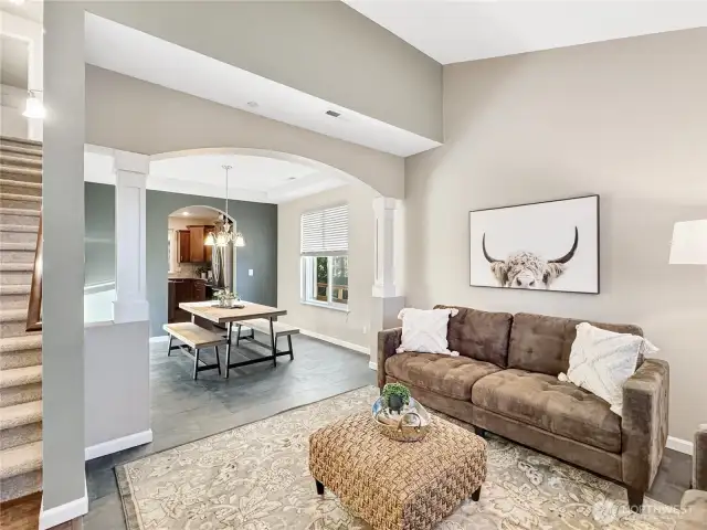 The great room leads into a formal dining room through a gorgeous archway.