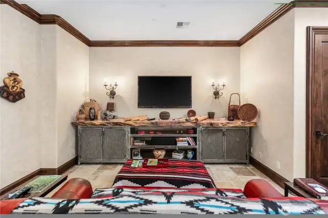 Custom built entertainment area separate from living room topped with 13 foot white oak slab