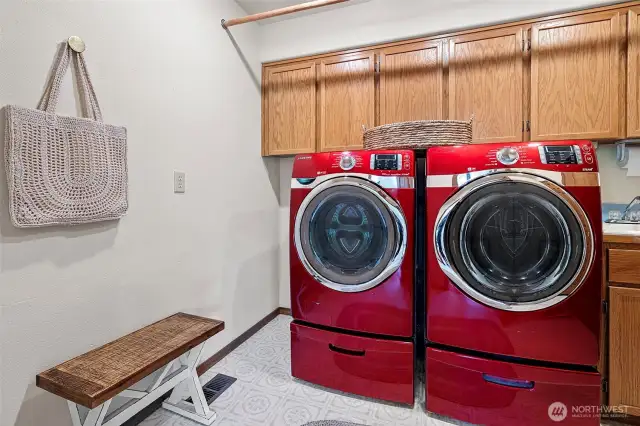 Main level laundry with sink and large cabinet space