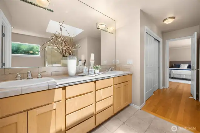 The skylight above drenches the primary en suite bath in natural light.