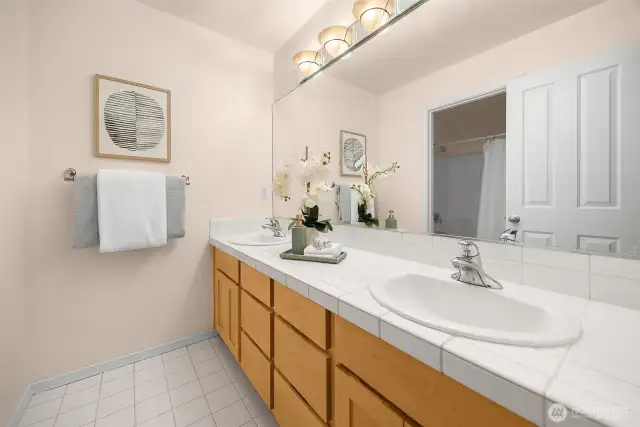 The hallway full bath on the upper level is separated into this dual-sink vanity, plus the tub/shower and loo behind the doorway you see in the mirror.
