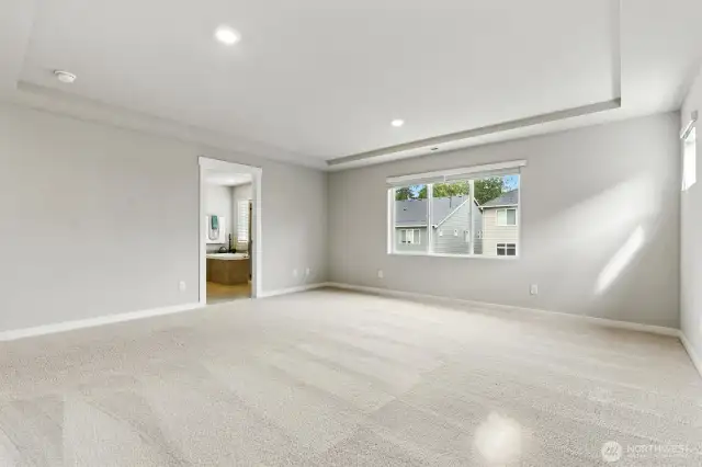 Primary bedroom with full en suite bathroom and walk in closet.