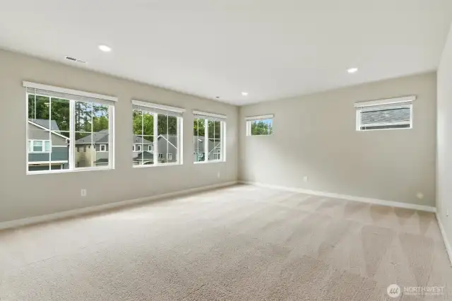 Upper level bonus room is an ideal hosting and gathering space.