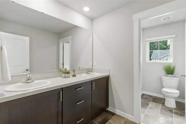 Upper level full bathroom with double sink and generous counter space