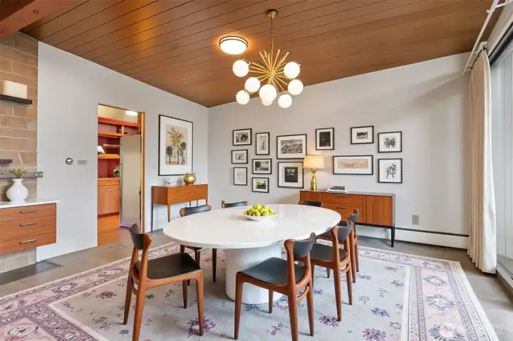 Virtually staged dining room, adjacent to the kitchen and with a sliding door to the front deck.