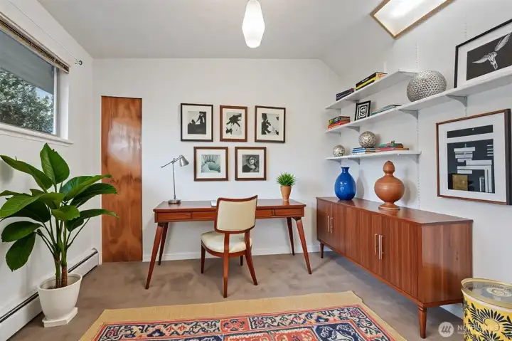 Virtually staged front bedroom or office.  Frosted skylights bring a special brightness to the room.