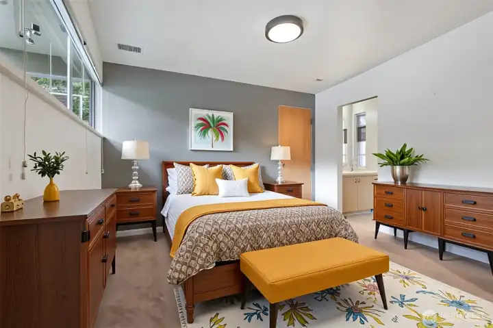 Virtually staged primary bedroom with attached 1/2 bath.