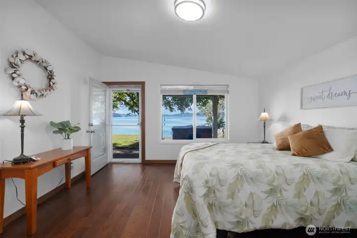 Primary bedroom enjoys the amazing views, vaulted ceiling and access to the rear deck, yard and hot tub.