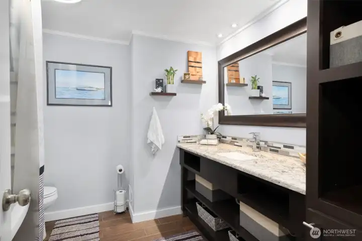 Full hall bathroom with tub and shower.
