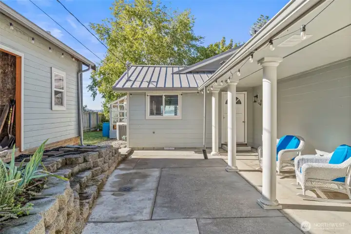 Side courtyard patio with storage building for wood and garden supplies.  Door to kitchen.