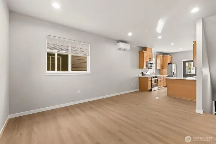Open great room with mini split heat and ac unit. Laminate flooring throughout