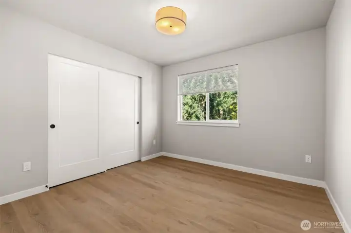 One of the 2 primary bedrooms with extra large closet space and private bath.