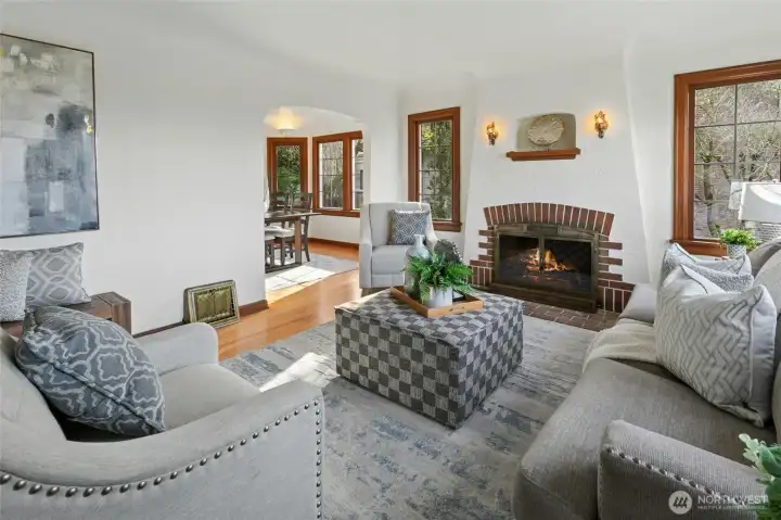 Cozy up in front of living room’s wood-burning fireplace with art nook and period light fixtures.